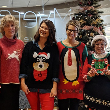 MorganMyers employees wearing Holiday sweaters