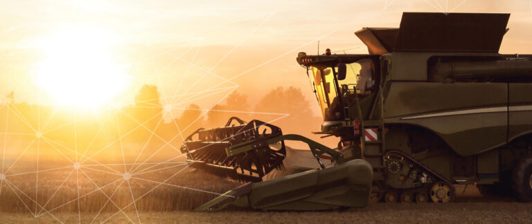 combine in field with sunrise